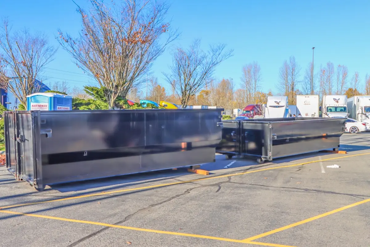 Professional dumpster rental service with roll-off container on residential driveway in Montgomery Village